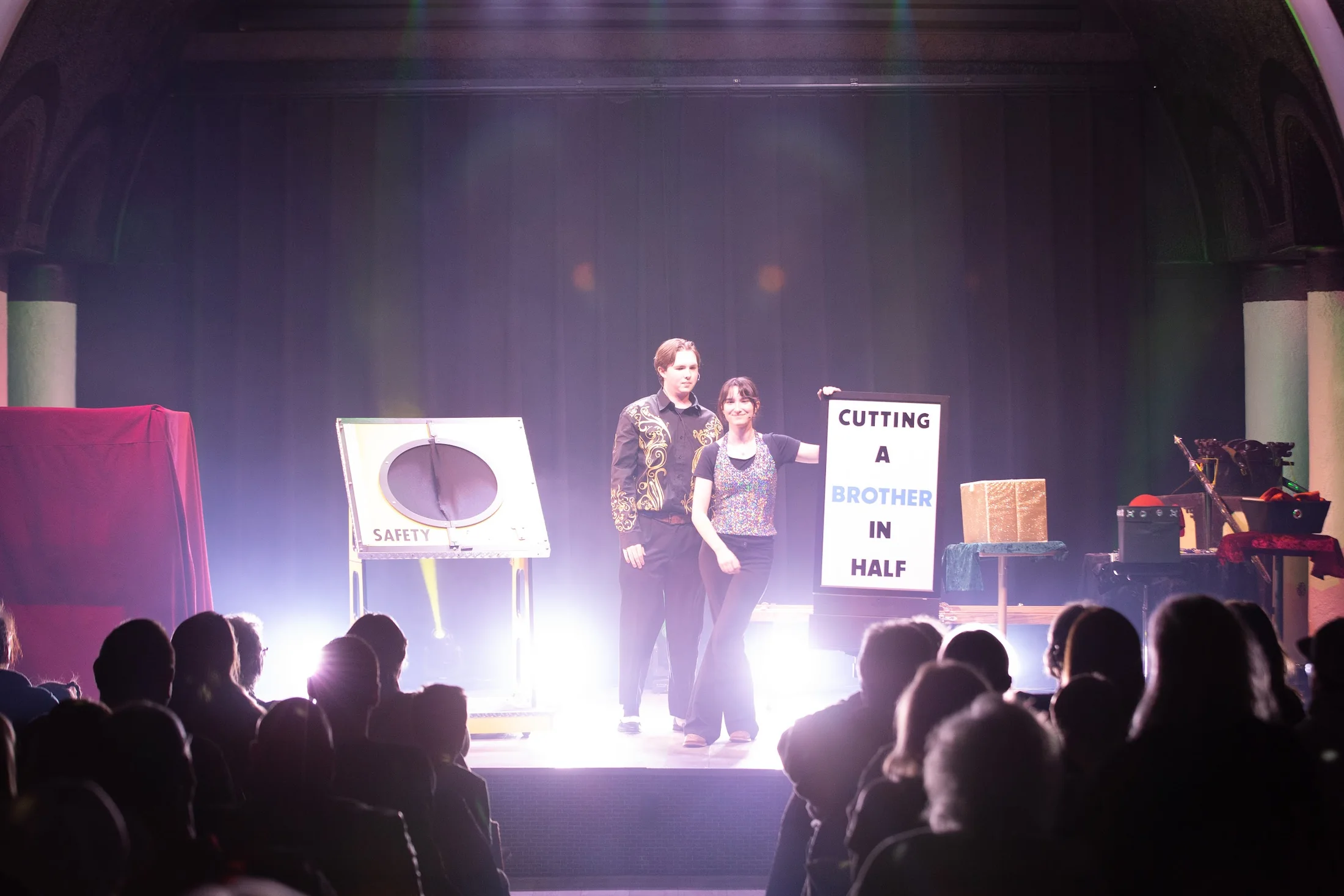 A live audience watching Sitruc James perform on a theatre stage